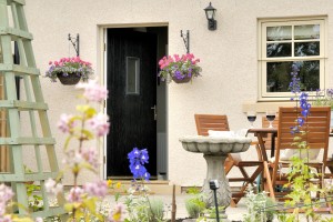 garden patio with table and chairs and flowers